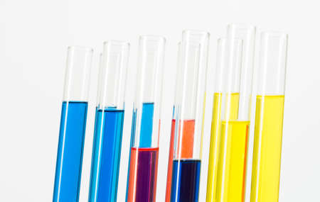 Science laboratory research and development. Close up test tubes with colorful substance on white background. Chemical manufacture concept with glass equipment. Modern biotechnology industry.の写真素材