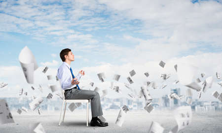 businessman sitting on an office chair, meditation and calmnessの写真素材