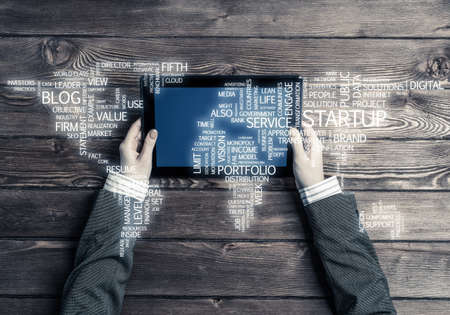 Top view of businesswoman sitting at table wooden with tablet pcの写真素材