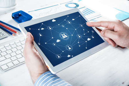 Mens hands hold a computer tablet. Social media concept