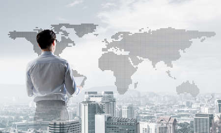 Double exposure of elegant businessman with papers in hands looking awayの写真素材