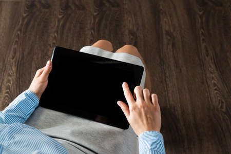close-up of female hands with a computer tabletの写真素材