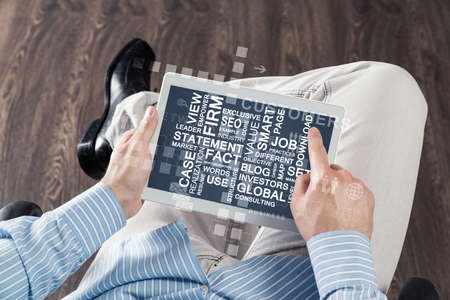 close-up of male hands with a computer tabletの写真素材