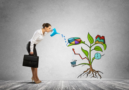 Attractive businesswoman presenting investment and financial growth conceptの写真素材
