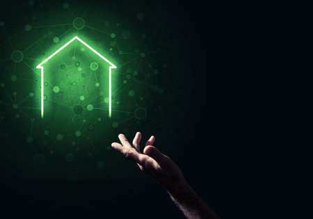 Hand of man touching with finger glowing home icon or symbolの写真素材