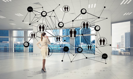 Elegant businesswoman in modern office talking mobile phone and social connection concept. Mixed mediaの写真素材