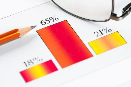 Business workplace with keyboard mouse and papers with graphs and diagramsの写真素材