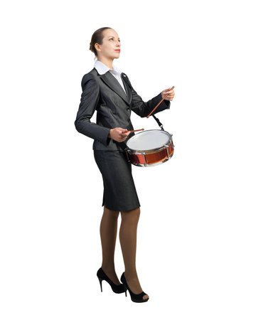 Businesswoman plays the drum. Pace and rhythm in doing business. On a white background.の写真素材