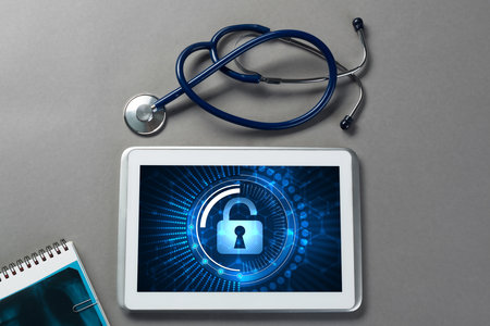 Doctors workplace with white tablet stethoscope and maskの写真素材