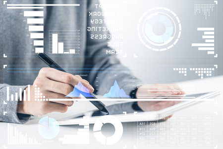 Stockbroker working with financial information at tablet computer. Interactive stock market tracking graph, trading indicators and exchange indexes. Global financial investment and trading conceptの写真素材