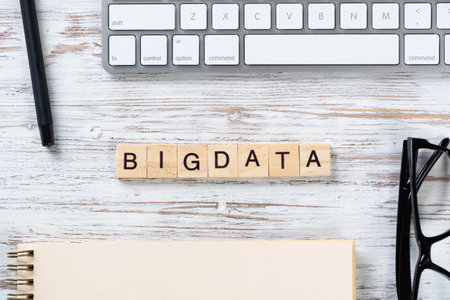 Big data analytics concept with letters on cubes. Still life of workplace with supplies. Flat lay...