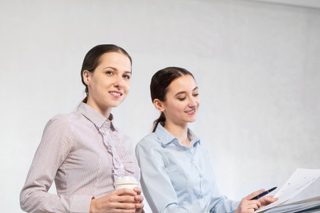 two young women discuss documents. concept of teamworkの写真素材