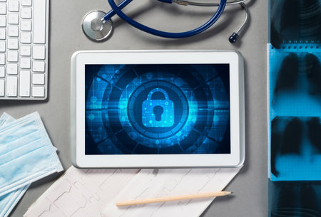 Doctors workplace with white tablet stethoscope and maskの写真素材