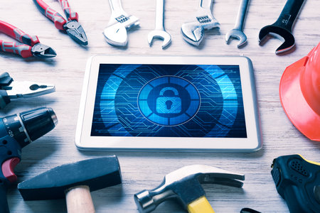 Tablet pc with security concept on screen and industrial tools aroundの写真素材