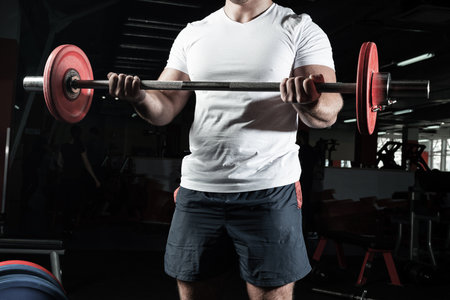 Man in the gym lifts the barbell. bodybuilding and healthy lifestyleの写真素材