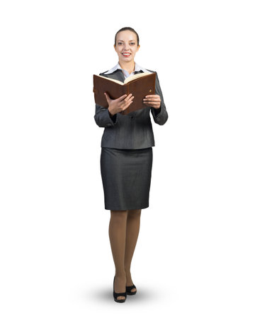 A businesswoman in a business suit stands with an open diary in her hands. On a white backgroundの写真素材