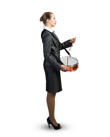 Businesswoman plays the drum. Pace and rhythm in doing business. On a white background.の写真素材