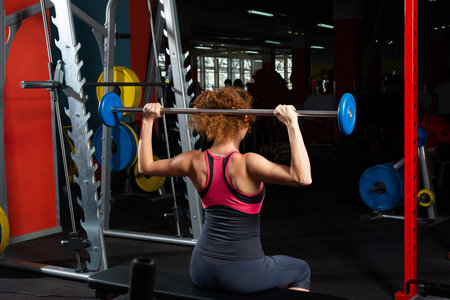 Woman bodybuilder engaged with a barbell in the gym. Healthy lifestyle.の写真素材
