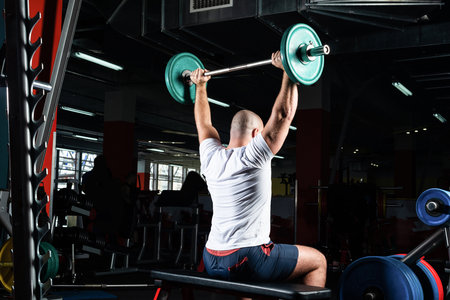 Man in the gym lifts the barbell. bodybuilding and healthy lifestyleの写真素材