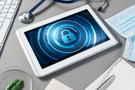 Doctors workplace with white tablet stethoscope and maskの写真素材