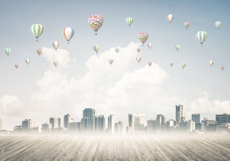 Modern cityscape with buildings and skyscrapers covered with fog and balloons in skyの写真素材