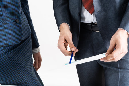 Corporate teamwork concept with business people. Idea presentation and strategy planning. Office desk with financial documents. Investment project analysis and discussion. Business meeting in officeの写真素材