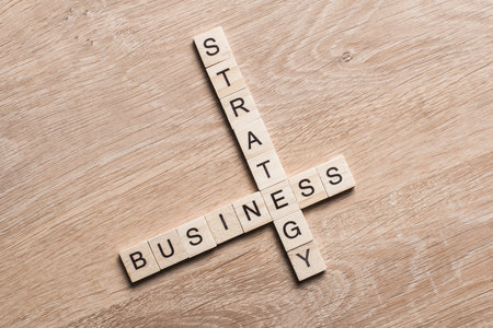 Words of business marketing collected in crossword with wooden cubesの写真素材