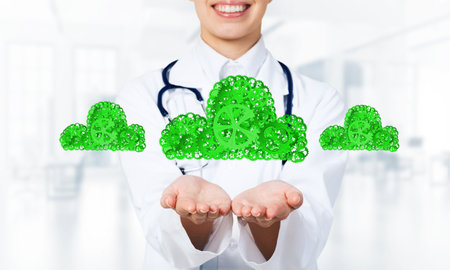 Close of woman doctor holding in palms cloud of gear mechanismの写真素材