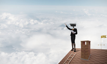 Faceless businesswoman with camera zoom instead of head standing on house roofの写真素材
