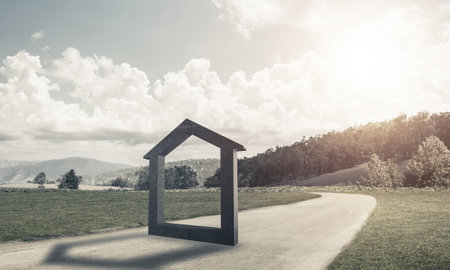House stone figure as symbol of real estate outdoors against natural landscapeの写真素材