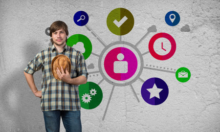 Young guy and color application icons at backgroundの写真素材