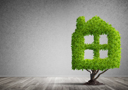 House shaped green tree as real estate conceptの写真素材