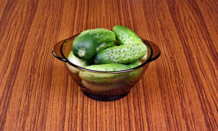 Young fresh cucumbers in a bowl for pickling vinegarの写真素材