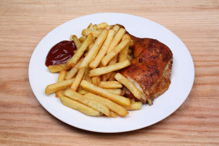 Lunch is fried fries and baked chicken legの写真素材