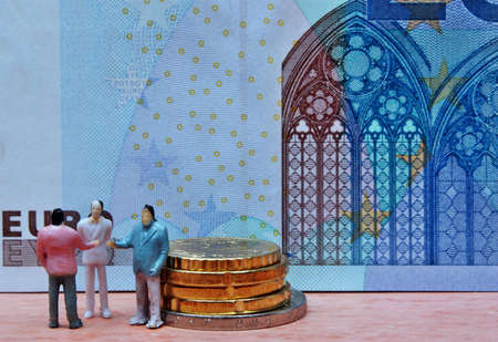 Miniature men in background  money