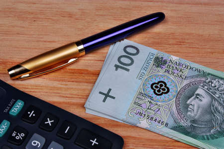 Polish money calculator pen on the tableの写真素材