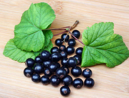 Fresh blackcurrants on a wooden tableの写真素材