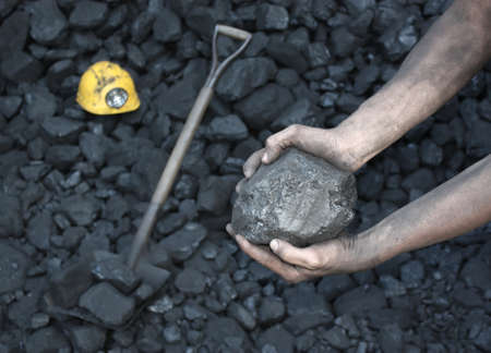 Miner worker showing stone coalの写真素材