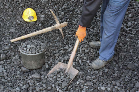 Miner working at shoveling coal mineの写真素材