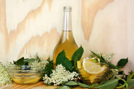 Elderflower syrup on wooden and fresh flowerの写真素材