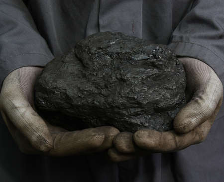 Coal in the hands of a minerの写真素材