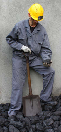 Holding a stone coal miner with a shovel miningの写真素材