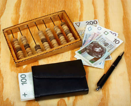 Polish money, pen, wallet and abacus