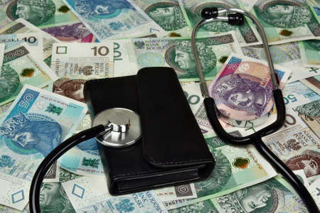 Stethoscope and wallet on polish money background - medical conceptの写真素材