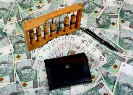 Polish money, pen, wallet, abacus on the banknote backgroundの写真素材