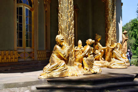 Potsdam, Germany - May 19, 2013: Golden statue in the Chinese house in Sanssouci Parkのeditorial素材