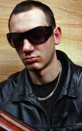 Menacing gangster mafia criminal shoots a gunの写真素材