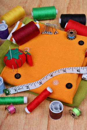 Background vertical with sewing items: buttons, colorful fabrics, material, measuring tape, bobbins,...