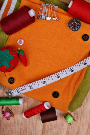 Background vertical with sewing items: buttons, colorful fabrics, material, measuring tape, bobbins,...