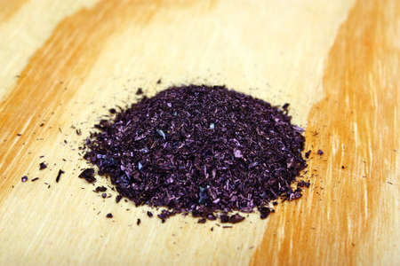 Pile of potassium permanganate crystals on a wooden tableの写真素材